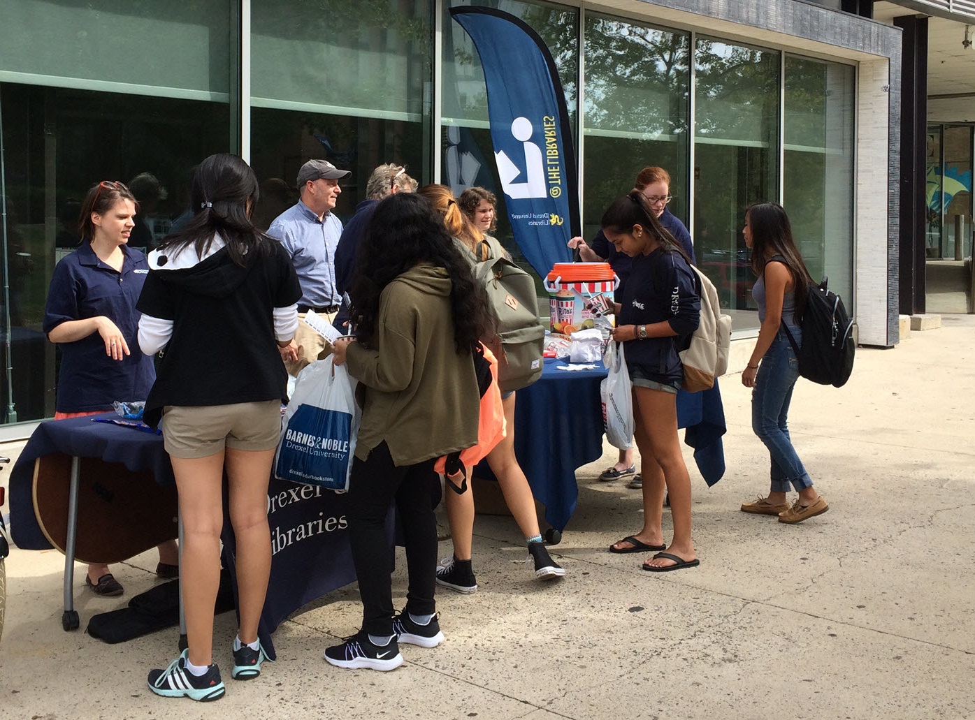 Drexel students wait in line for water ice in front of the Library Learning Terrace